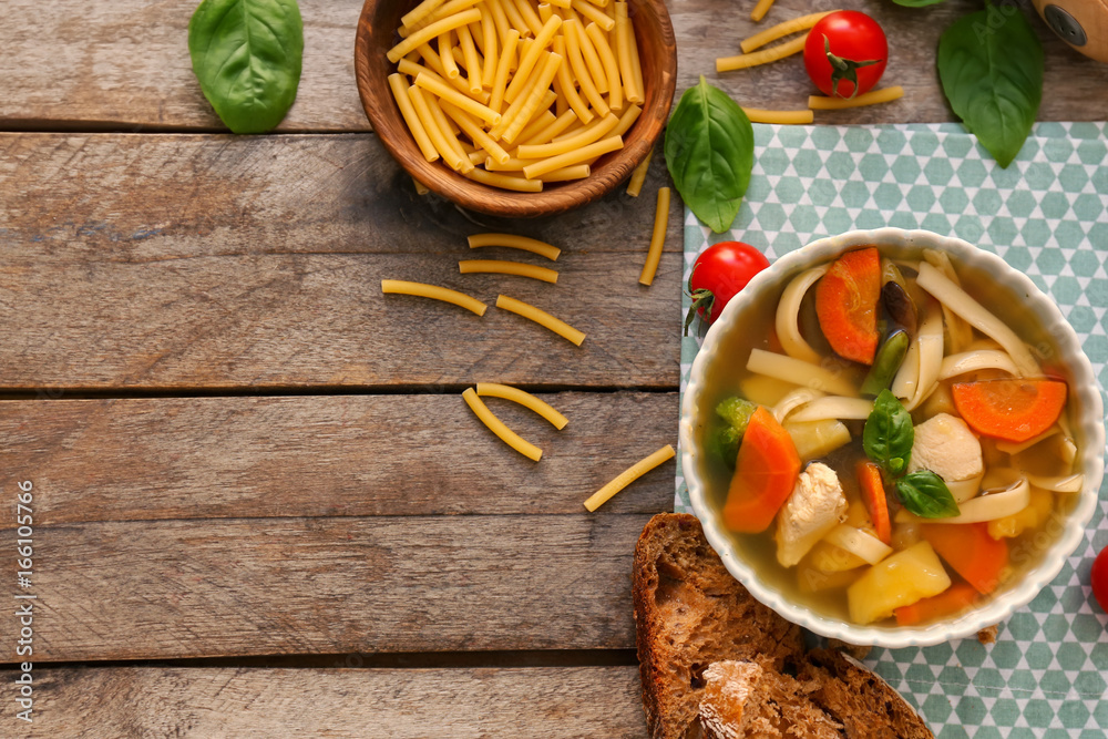 Bowl with delicious turkey soup on wooden background Bowl with delicious turkey soup on wooden background