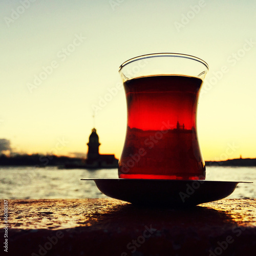 glass of Turkish tea against maiden's tower in Istanbul, Turkey