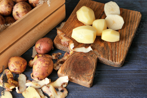 Composition with raw organic potatoes on wooden table