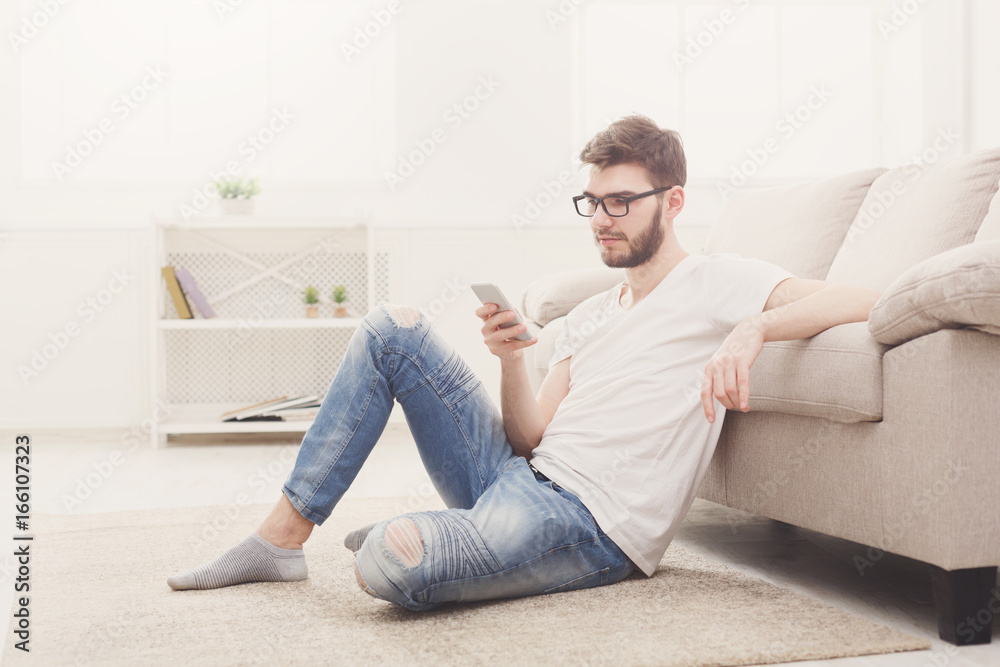 Young man at home messaging online