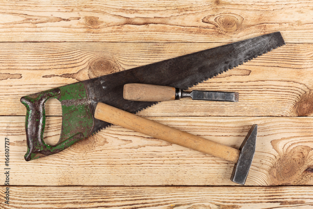 Old carpentry tools on a wooden background