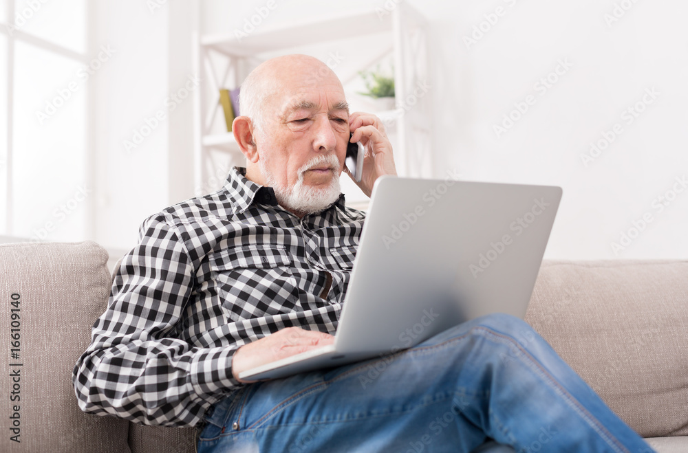 Senior man talking on phone with laptop Senior man talking on phone with laptop