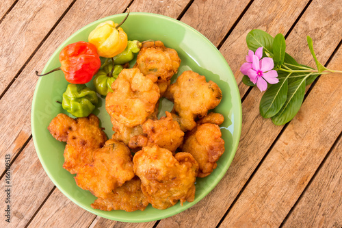 Salt cod fritters (accras de morue) on a plate with habanero peppers in Martinique