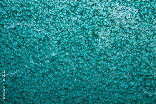 green or turquoise hammered metal background,abstract metalic texture, sheet of metal surface painted with hammer paint. photo