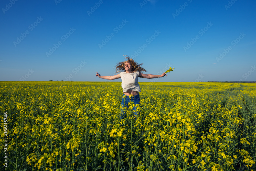 Happy young woman, with flying hair and open arms jumping Happy young woman, with flying hair and open arms jumping