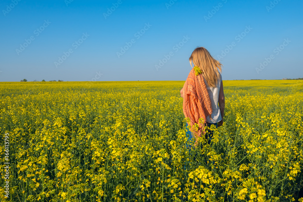 Romantic young woman in field of yellow flowers Romantic young woman in field of yellow flowers