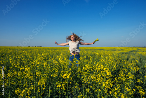 Happy young woman, with flying hair and open arms jumping © sanechka