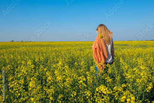 Romantic young woman in field of yellow flowers © sanechka
