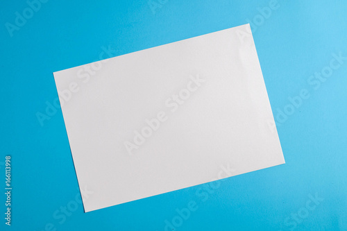 white torn paper with blue background, ready for design © Nattapol_Sritongcom
