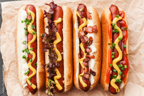 Barbecue Grilled Hot Dogs with  yellow American mustard, On a dark wooden background