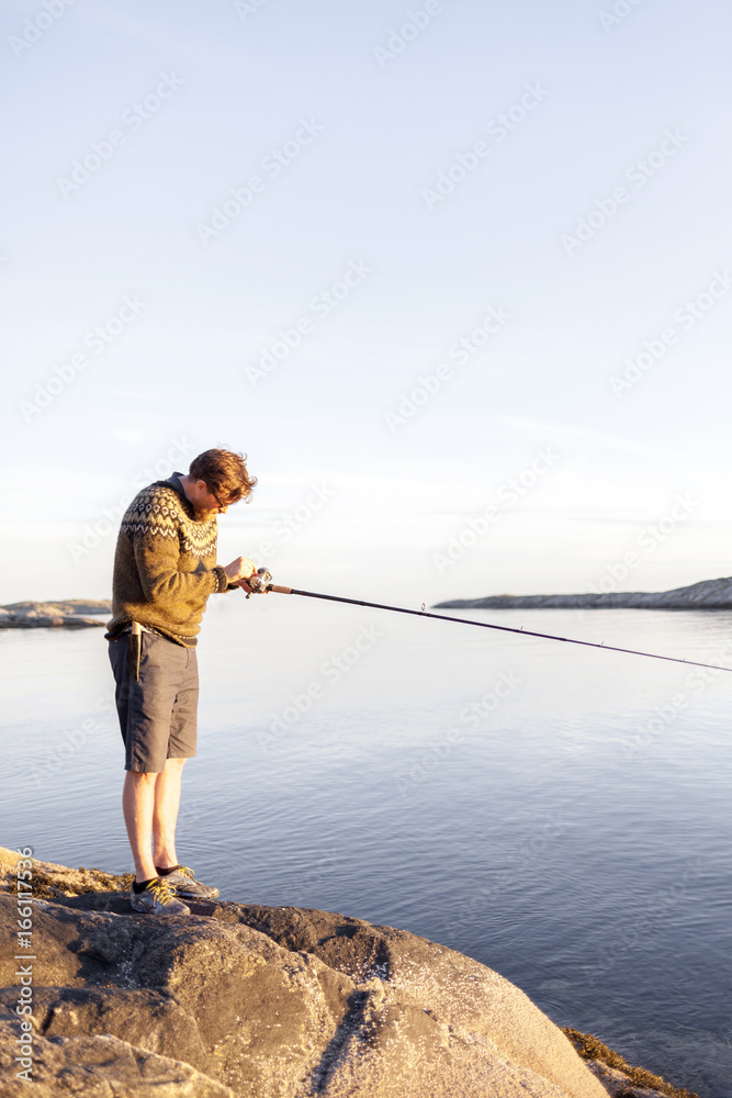 A man fishes for cod on the Lofoten island in Norway A man fishes for cod on the Lofoten island in Norway