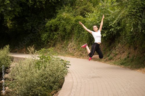Young Lady Jumping In Wooded Forest