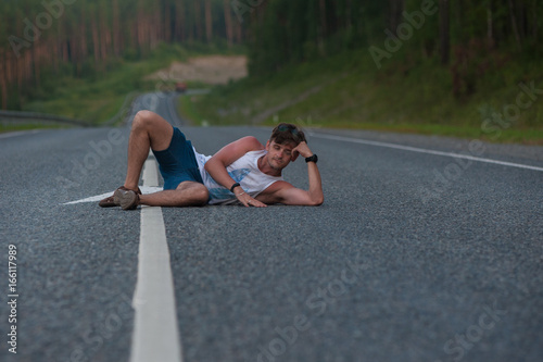 Man laying on the road