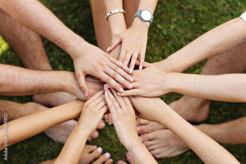 Group of friends bonding hands together