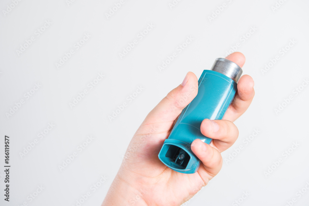 .Inhaler for relief of allergy and asthma attacks in the hand close up .Inhaler for relief of allergy and asthma attacks in the hand close up
