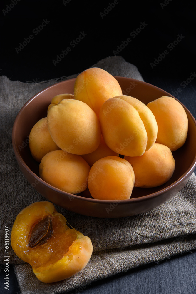 Juicy riped apricot on dark background