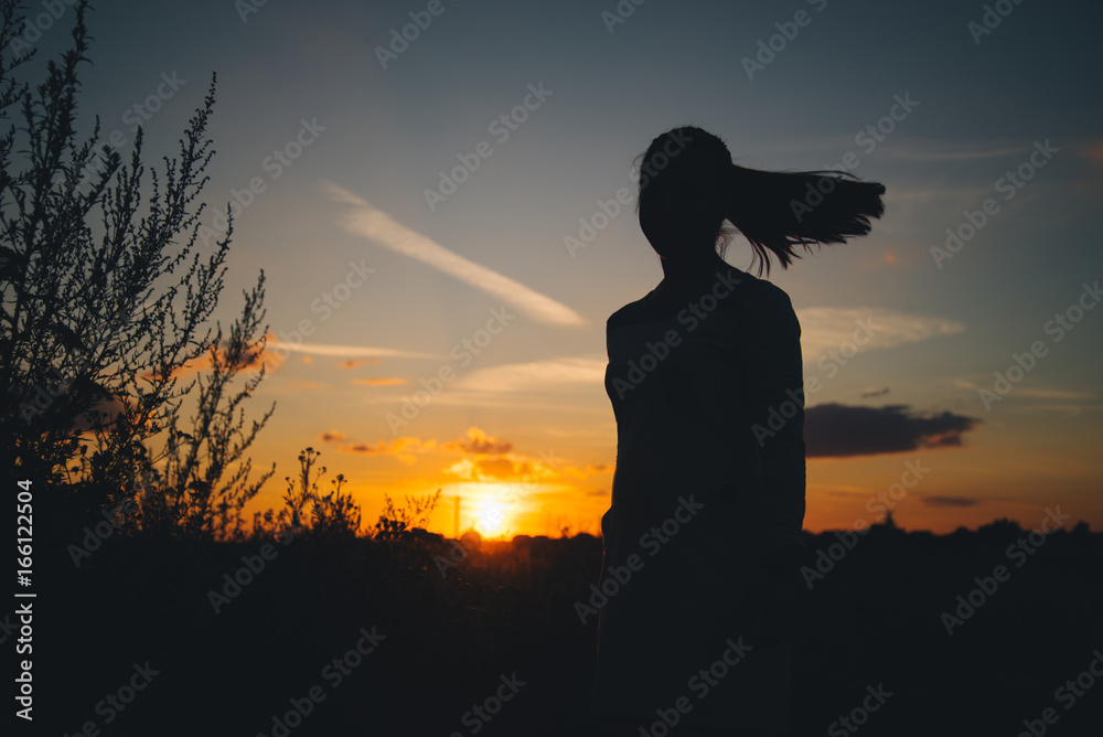 Silhouette of a woman with evening sky