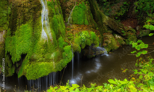 Wide long-exposure shot of very unusual and exquisite Bigar Waterfall in Transylvania, Romania, ranked by various renowned publications as the most beautiful waterfall in the world. 