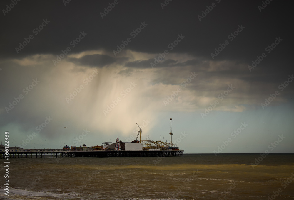 Shot of the Brighton Pier in England, UK against a dramatic sky
