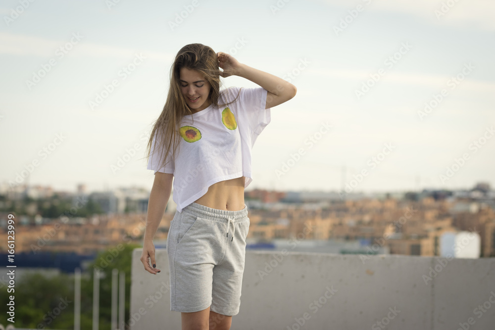 Young female balancing in the roof Young female balancing in the roof