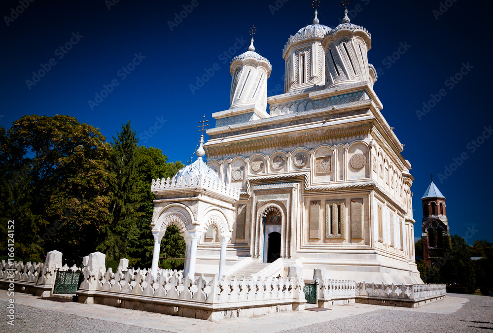 Ultra wide angle shot of a white Orthodox church in Curtea de Arges, Transylvania, Romania