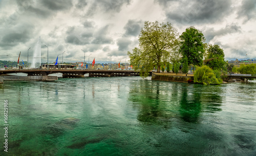 Wide shot of lake Geneva during daytime against a dramatic sky, Switzerland