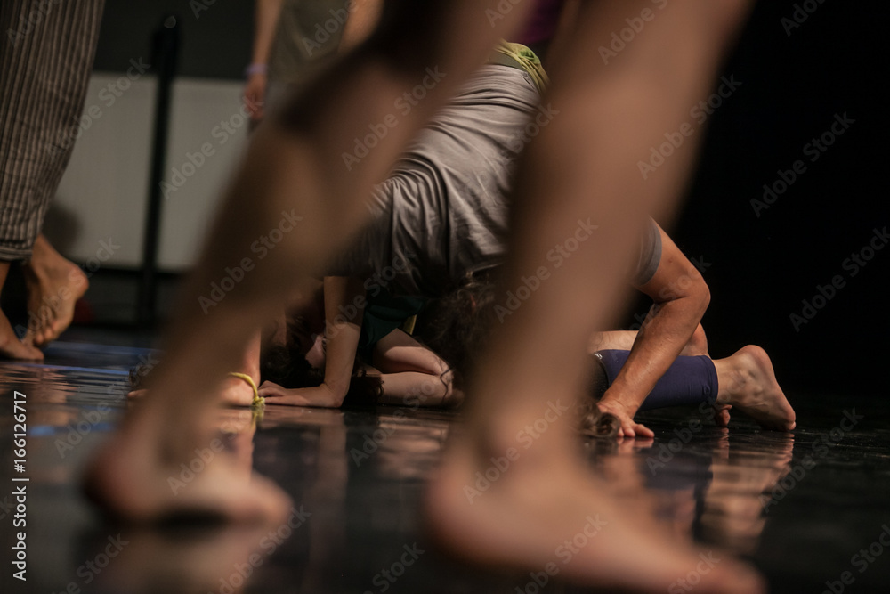 Naklejka premium dancers foots, legs,dacers legs, barefoots in motion near floor on blurred background