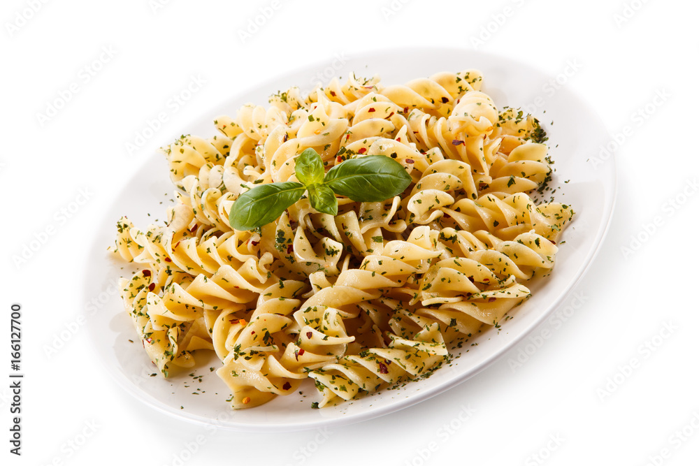 Pasta with herbs and basil on white background