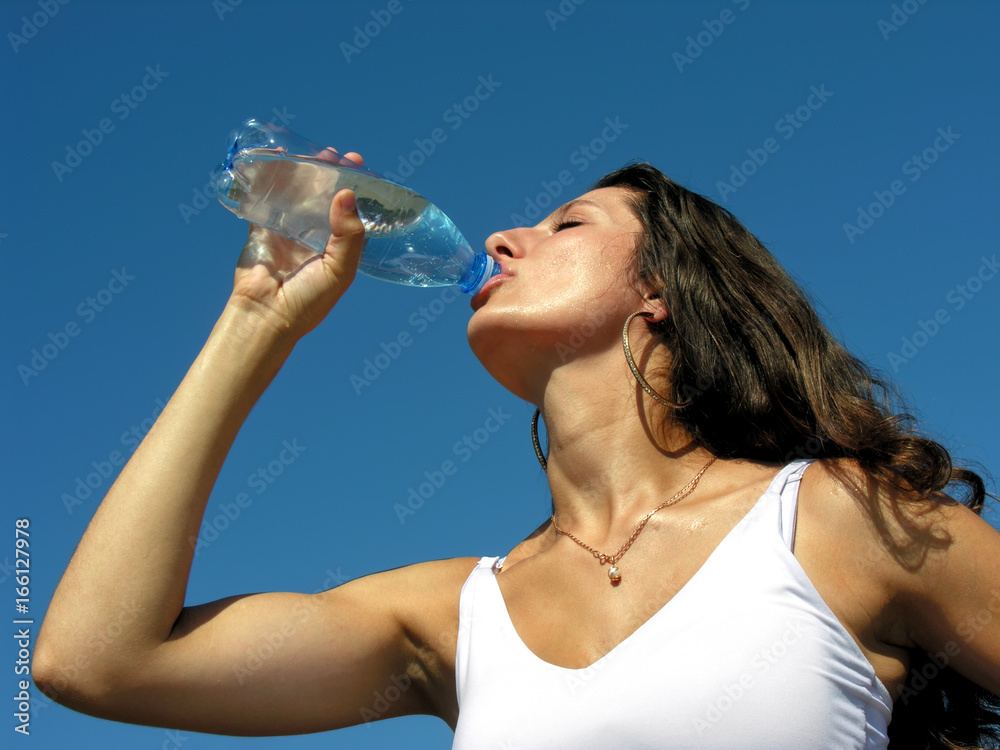 Thirst. Young woman drinks cold water in hot day Thirst. Young woman drinks cold water in hot day