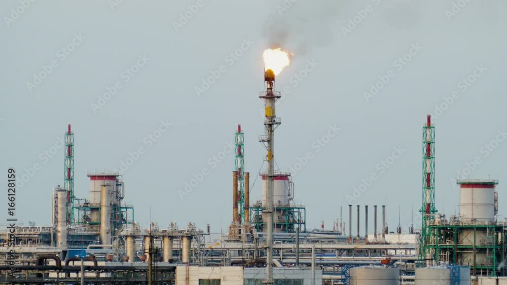 burning torch at the refinery against the grey sky burning torch at the refinery against the grey sky