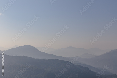 Mountain and fog with orange to blur sky in the morning in winter in Gangtok. North Sikkim, India