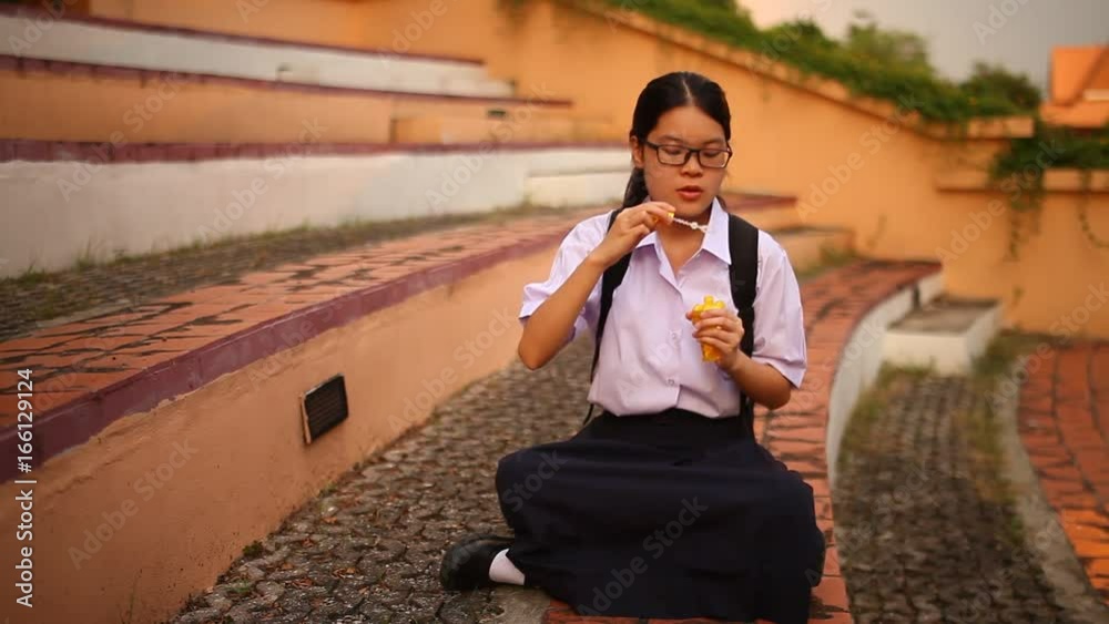 Thai student girl blowing bubbles at park Thai student girl blowing bubbles at park
