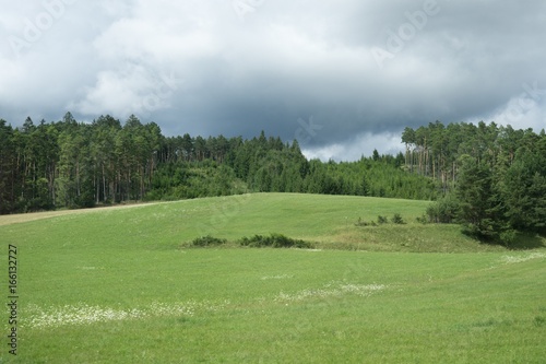 Green meadow and hills during sunny and cloudy afternoon. Slovakia