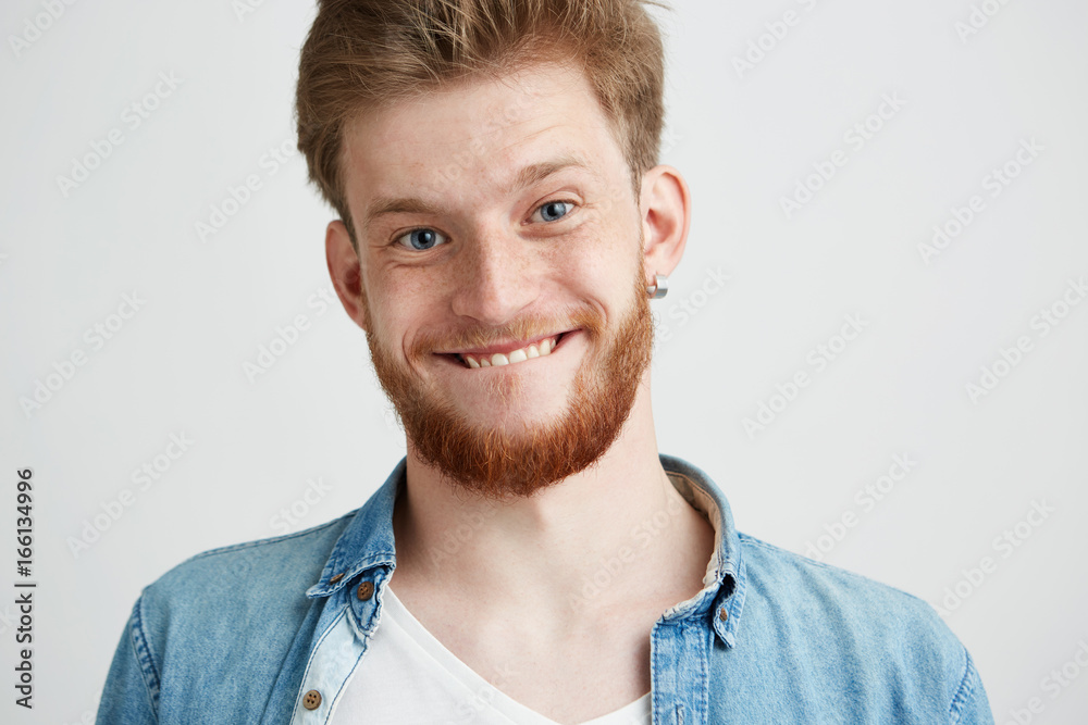 Portrait of young cheerful merry guy making funny face fooling looking at camera over white background. Portrait of young cheerful merry guy making funny face fooling looking at camera over white background.