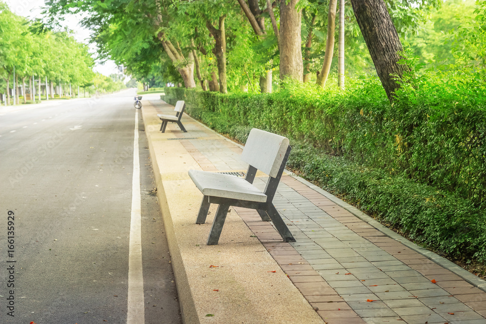Benches set up along the road for people to sit and relax.