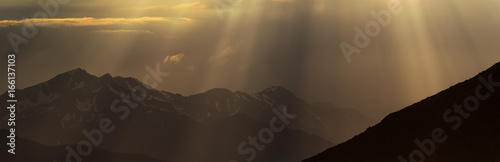 Greater Caucasus Mountain Range in beams of evening sun.