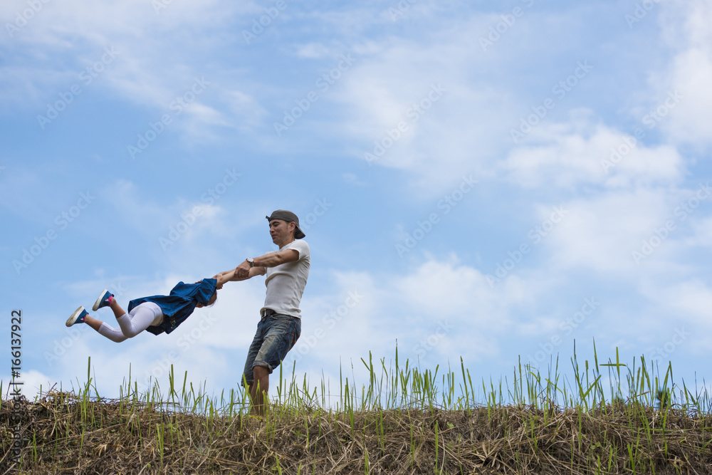 Father and daughter playing in the meadow Father and daughter playing in the meadow