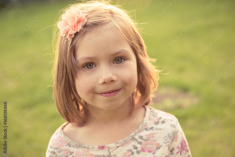 Portrait of a smiling little girl outdoors. Close-up Portrait of a smiling little girl outdoors. Close-up