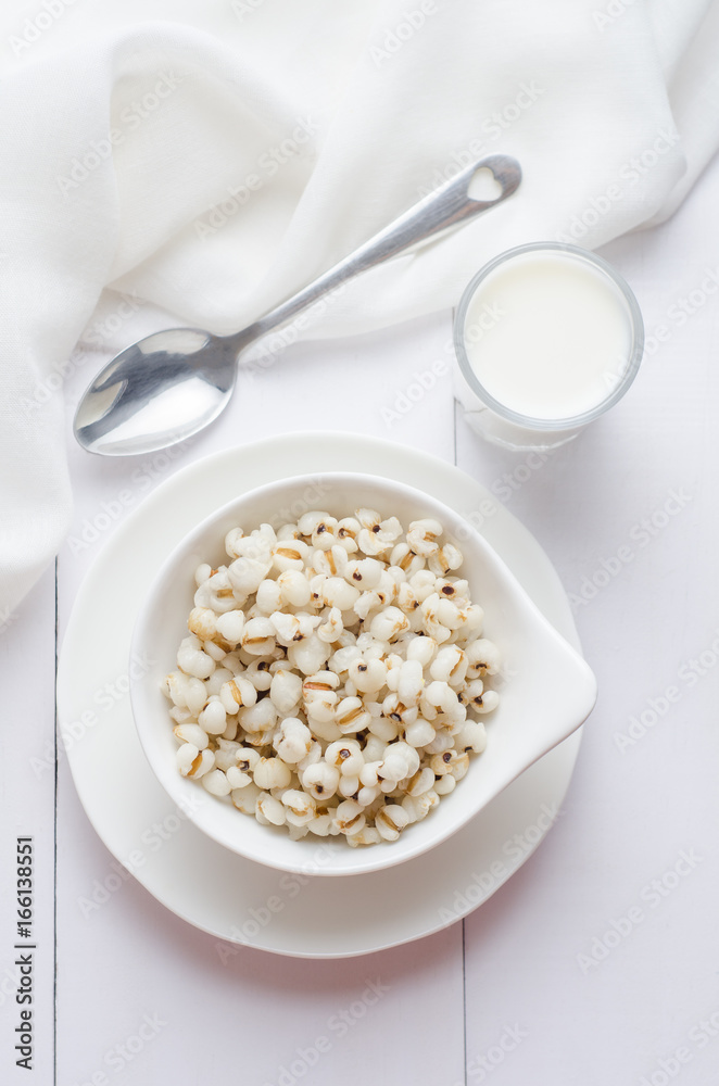 Healthy breakfast with boiled job's tears porridge in white bowl on wooden table. Healthy breakfast with boiled job's tears porridge in white bowl on wooden table.