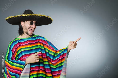 Man in a vivid mexican poncho gray background isolated Fototapet