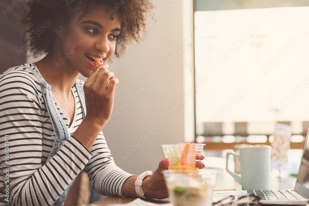 Delightful young woman is sitting at table in restaurant Delightful young woman is sitting at table in restaurant