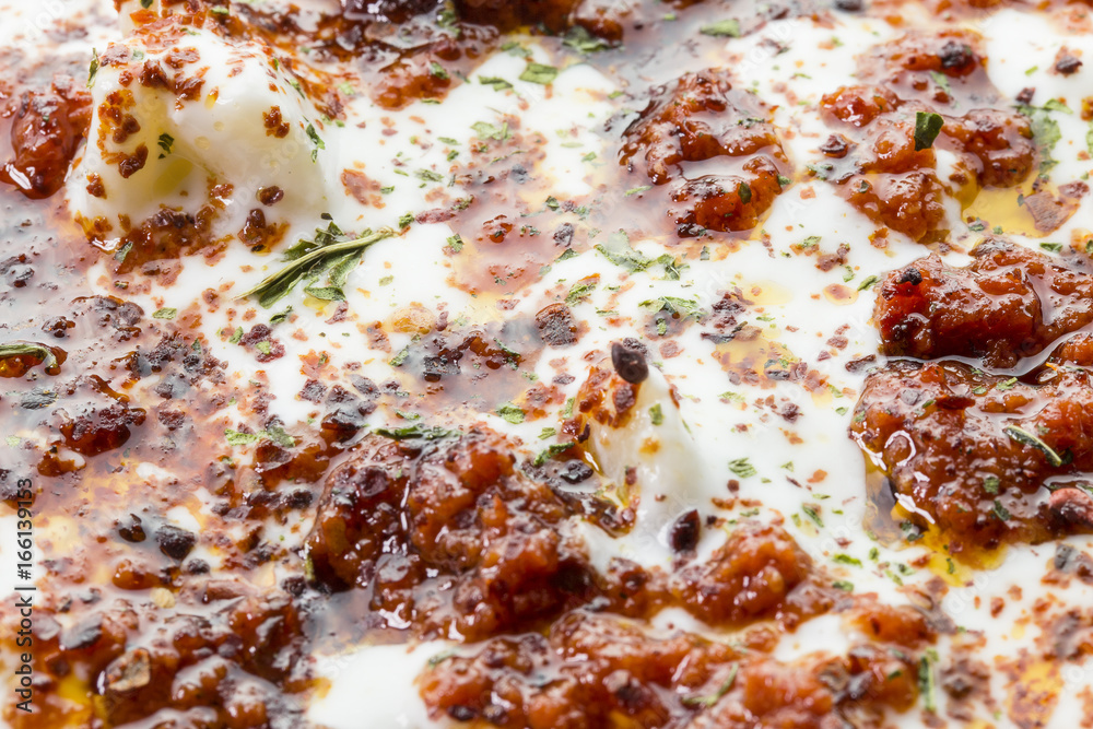 Turkish Ravioli with yogurt and tomato sauce . Plates of traditional Turkish food. Turkish Ravioli with yogurt and tomato sauce . Plates of traditional Turkish food.
