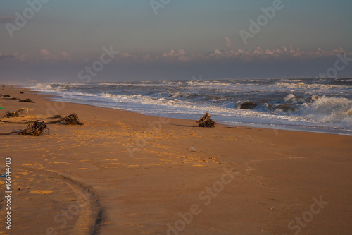 line of the surf on the sandy beach at sunset Anapa
