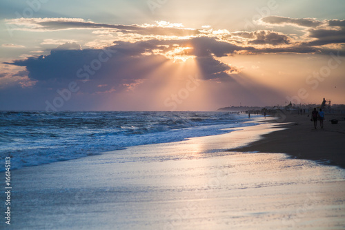 sea storm at sunset on the sandy beach