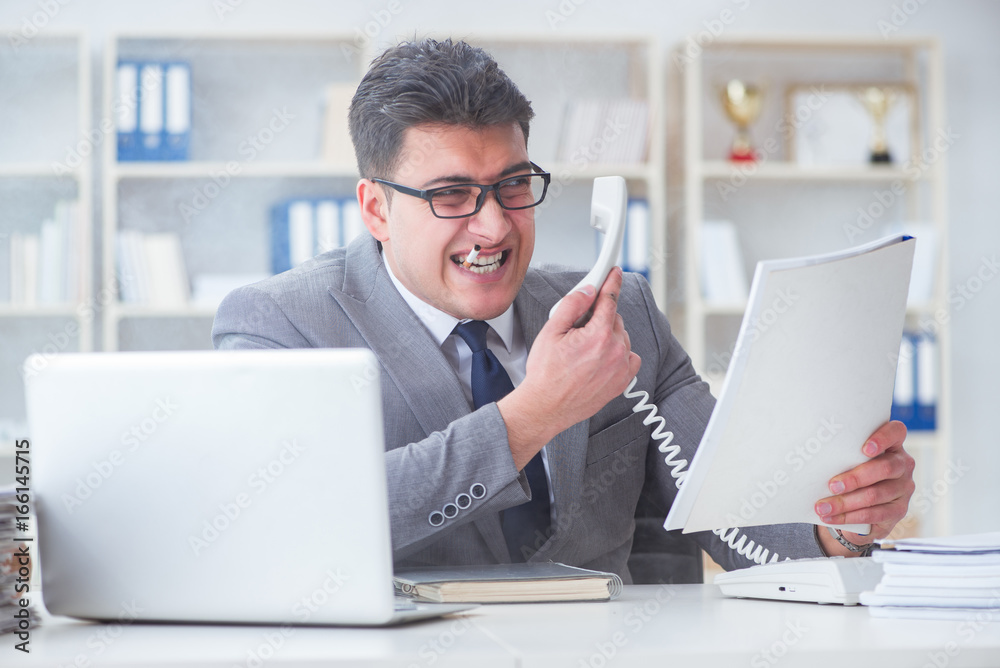 Businessman smoking in office at work