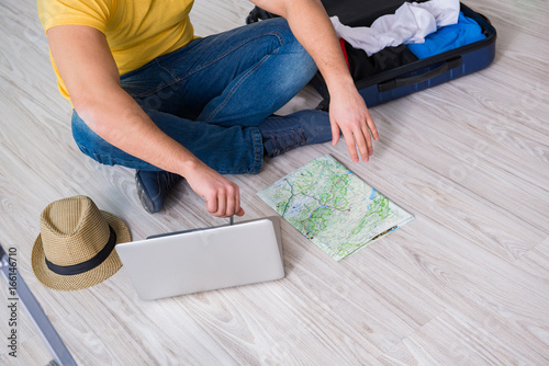 Fototapeta Naklejka Na Ścianę i Meble -  Man planning his vacation trip with map