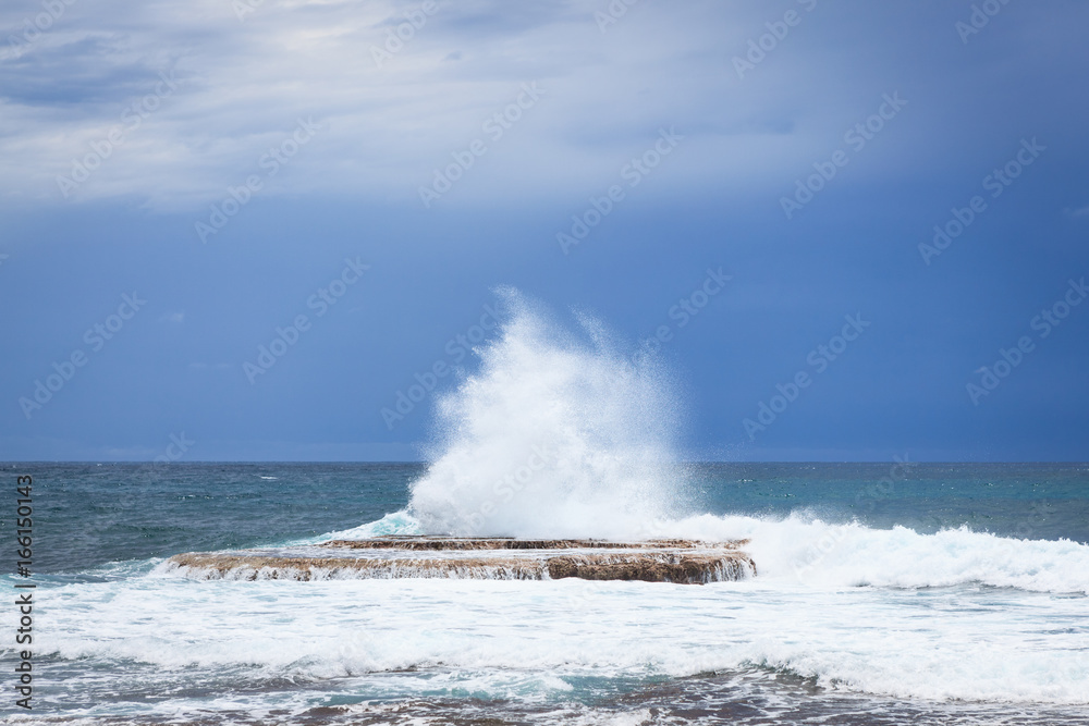 Waves crashing on rock