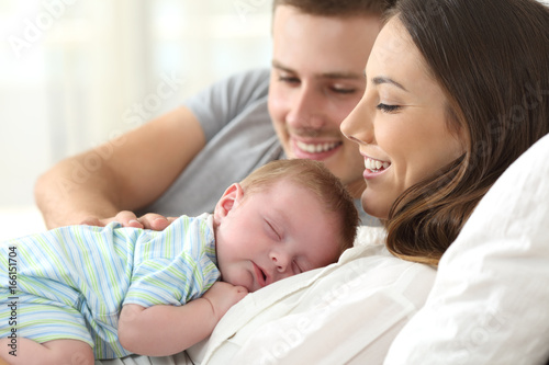 Parents watching their baby sleeping