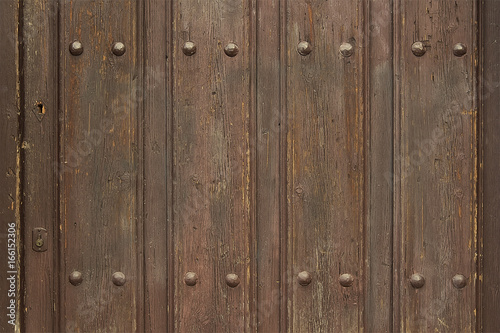 Old wooden door with metal elements © issalina