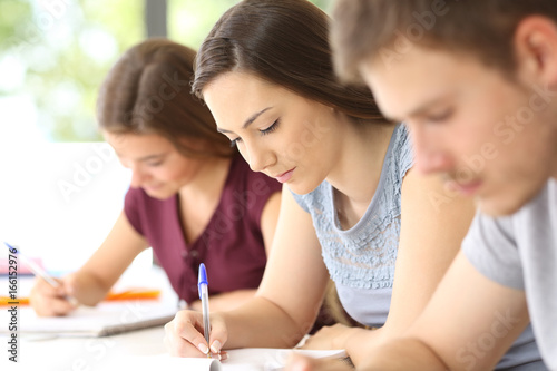 Close up of serious students taking notes